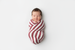 Newborn baby swaddled in Indiana University knit swaddle blanket with crimson and cream stripes - soft stretchy IU Hoosiers baby gift
