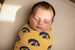 Baby swaddled in University of Iowa knit swaddle