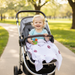 Happy toddler in stroller covered with University of Oklahoma Sooners 4-layer muslin blanket in crimson and cream, cozy outdoor lifestyle shot showing premium OU toddler blanket in use
