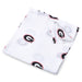 A folded white swaddle blanket with the University of Georgia Bulldog logo repeated throughout.